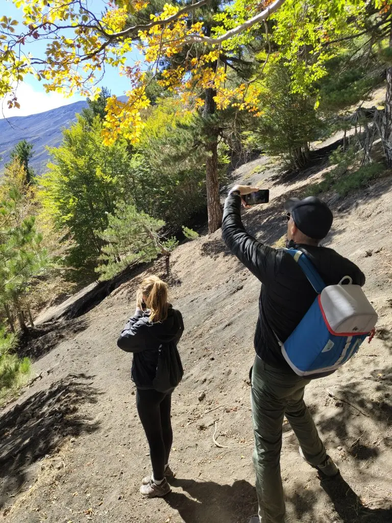 Hikers embracing the local culture of Mount Etna through stories and traditions